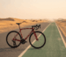 Polygon Strattos S7 road bike on a UAE desert cycle track at sunrise - Bikeera