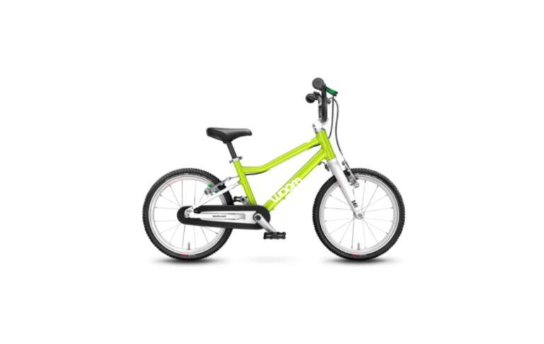 Lime-green Woom kids bike, sized and set up at the Bikeera store in Dubai