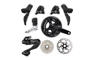 Complete Shimano 105 Di2 groupset laid out: levers, calipers, derailleurs, chainset, cassette and rotor
