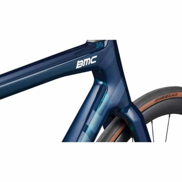 Close-up of the BMC Teammachine SLR 01 FIVE down tube and head tube in Blue Glitter Carbon with the Aerocore Design profile and Pirelli P Zero Race tyre