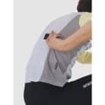 A phone being placed into the dedicated reinforced rear phone pocket of the Barbara V2 jersey