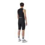 Rear view of the Cafe du Cycliste Cecile men’s bib short showing the mesh bib straps and reflective detail