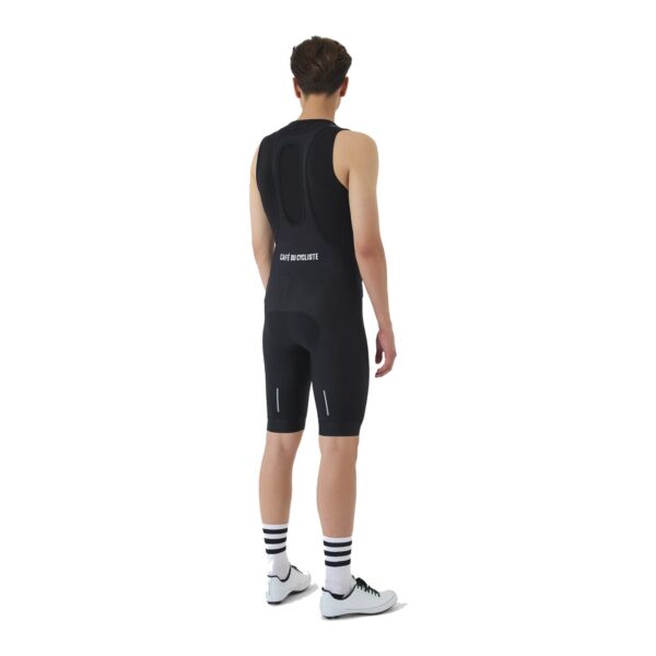 Rear view of the Cafe du Cycliste Cecile men’s bib short showing the mesh bib straps and reflective detail