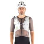 Cyclist wearing the UltRide Evo 8 hydration vest, front view showing the chest pockets and tightening system