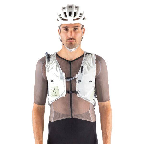 Cyclist wearing the UltRide Evo 8 hydration vest, front view showing the chest pockets and tightening system