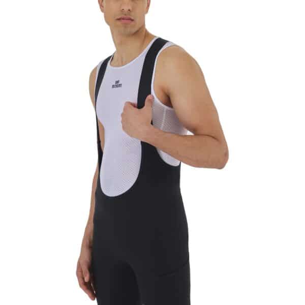 A phone being slid into the side cargo pocket of the black Eva V2 bib short