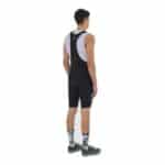 Rear view of a cyclist wearing the black Eva V2 cargo bib short