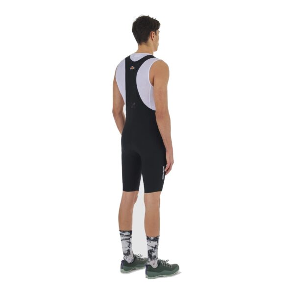 Rear view of a cyclist wearing the black Eva V2 cargo bib short