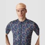 Cyclist wearing the Cafe du Cycliste Gapette cap in Dutch Coral