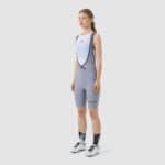 Cyclist wearing the Cafe du Cycliste Graziella bib shorts in Storm grey, front view