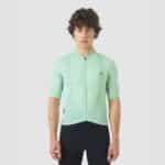 Cyclist wearing the Cafe du Cycliste Laurette jersey in Cold Dye Jadeite green, front view