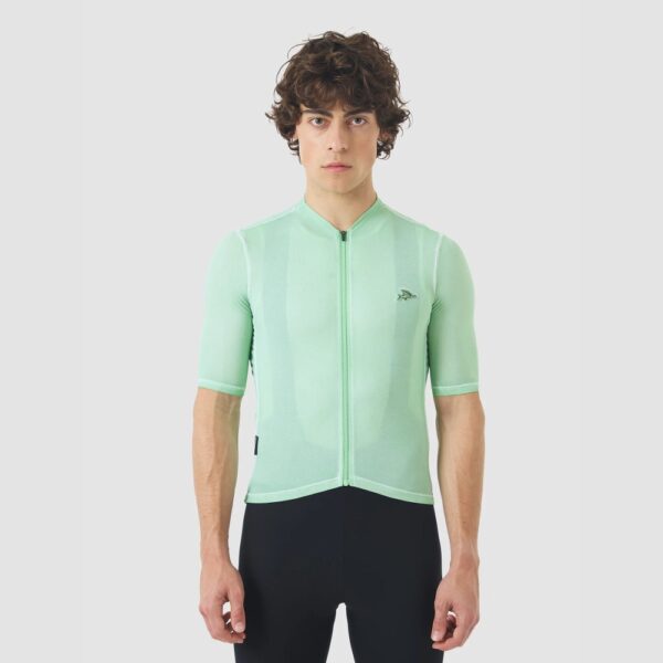 Cyclist wearing the Cafe du Cycliste Laurette jersey in Cold Dye Jadeite green, front view