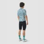 Cyclist wearing the Cafe du Cycliste Laurette jersey in Stars Dark Sea, back view showing the three rear pockets