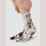 Cyclist wearing the Cafe du Cycliste Tie Dye socks in Charcoal