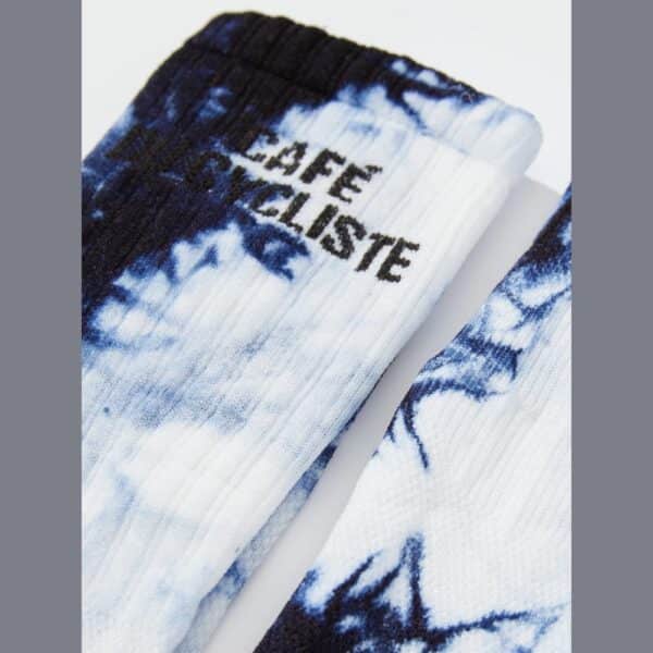 Close-up of the knitted high cuff and Cafe du Cycliste logo on the Tie Dye socks
