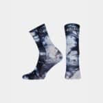 Pair of Cafe du Cycliste Tie Dye socks in Navy showing the high cuff and logo