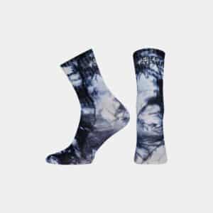 Pair of Cafe du Cycliste Tie Dye socks in Navy showing the high cuff and logo
