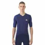 Male cyclist wearing the navy Cafe du Cycliste Vinciane jersey, front view showing the close performance fit