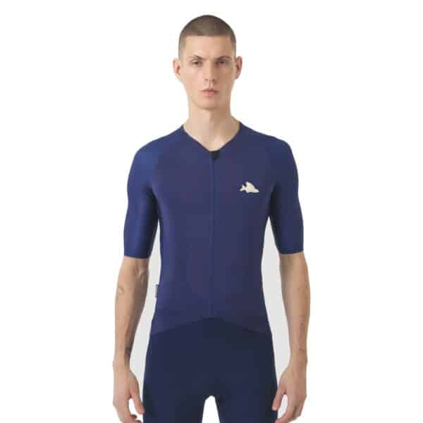 Male cyclist wearing the navy Cafe du Cycliste Vinciane jersey, front view showing the close performance fit