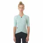 Woman wearing the jadeite Cafe du Cycliste Vinciane jersey, front view showing the close performance fit
