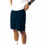 Dérive DRFT men’s cargo shorts in black, front view on model, drawcord waistband and cargo pocket with Dérive logo