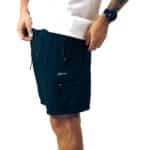 Dérive DRFT black cargo shorts, three-quarter view showing the drawcord and flap cargo pocket