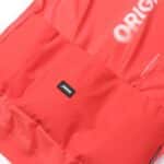 Dérive Origin jersey in _Dérive Red, rear pocket with _Dérive logo tab