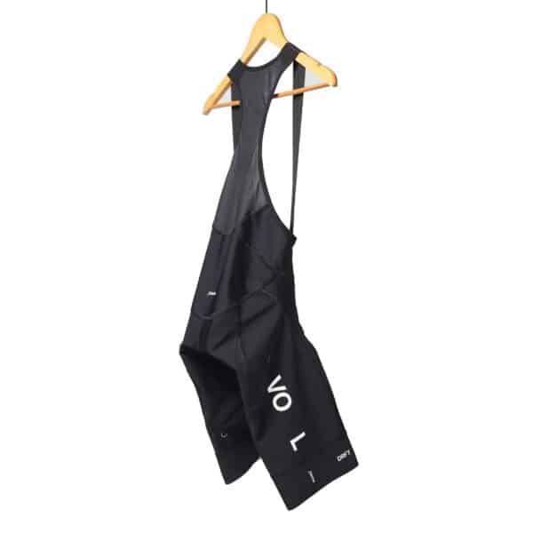 Dérive Volume women’s bib shorts in Black, side view with VOLUME leg print