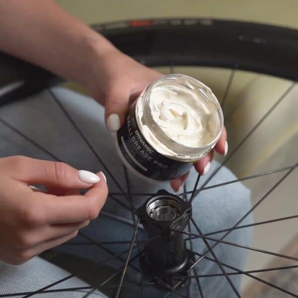 Open jar of Dynamic Galli Grease Pro showing the white bearing grease inside