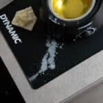 Dynamic Mat Max catching spilled chain wax flakes next to a Waxifyer hot wax pot
