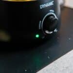 Close-up of a Waxifyer hot wax pot with melted wax on the Dynamic Mat Max