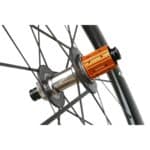 Close-up of the Farsports Ultimate EVO S5 rear hub, orange Shimano HG freehub body and oversized carbon hub flange