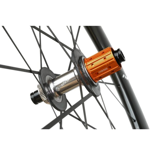 Close-up of the Farsports Ultimate EVO S5 rear hub, orange Shimano HG freehub body and oversized carbon hub flange