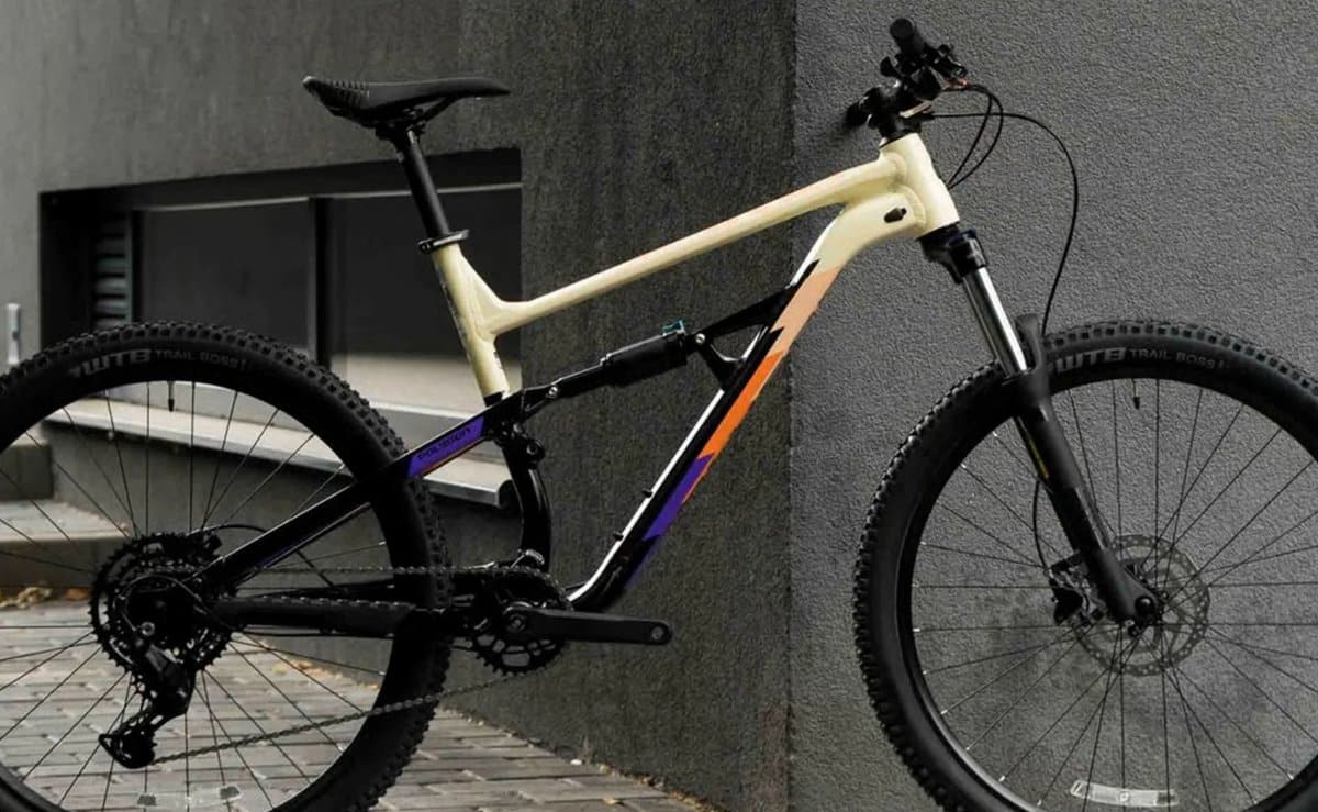 Polygon Siskiu D5 full suspension mountain bike in Cream/Orange photographed outdoors, showing its modern trail geometry and 760 mm handlebar