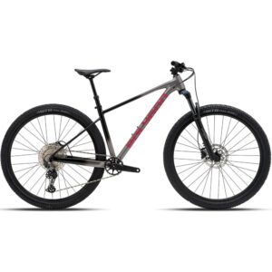 Polygon Xtrada 6 hardtail mountain bike in Charcoal Black with red Polygon logo, 29-inch wheels, side view