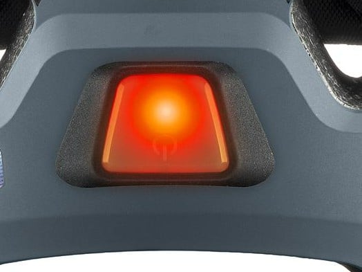Close-up of the plug-in rear LED lit red on the uvex stride visor MIPS helmet