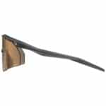 uvex ultimate pace ultra V CV photochromic sports glasses, black matt frame with variomatic colorvision mirror red lens, side view showing the temple arm and rubberised tip
