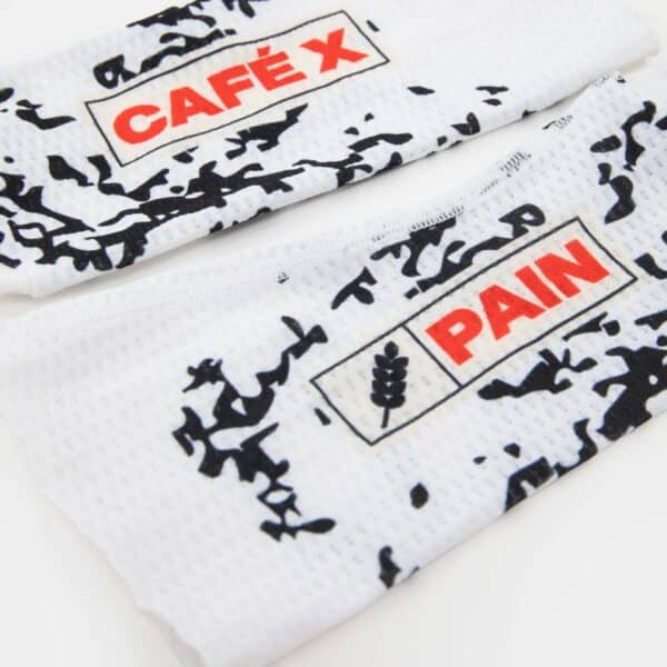Close-up of the CAFÉ X PAIN logo and mesh on the Café du Cycliste Aero Socks