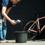 Pouring Dynamic Super Soap Concentrate into a bucket to make a bucket of cleaning foam