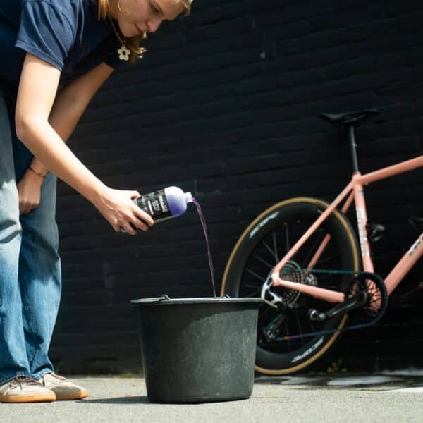 Pouring Dynamic Super Soap Concentrate into a bucket to make a bucket of cleaning foam