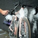 Covering a road bike in thick foam made with Dynamic Super Soap Concentrate in a foam sprayer