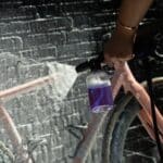 Spraying thick Dynamic Super Soap foam onto a bike frame with a foam sprayer