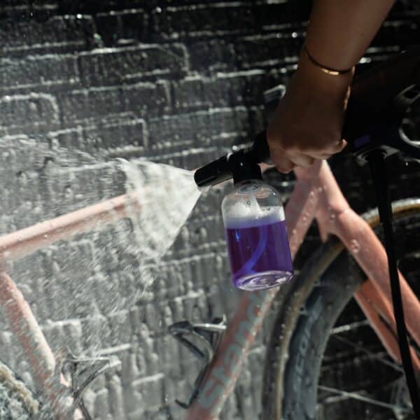 Spraying thick Dynamic Super Soap foam onto a bike frame with a foam sprayer