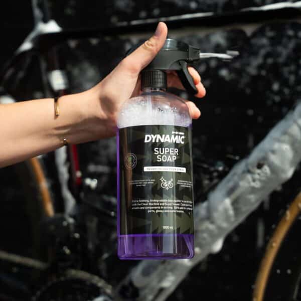 Dynamic Super Soap 1 L spray bottle held next to a foam-covered bike