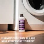 Dynamic Washcraft Pro next to a washing machine: eliminates sweat, body oils and grime with Pristine Technology