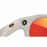 Close-up of the built-in camera on the Oakley Meta HSTN Warm Grey frame next to the Prizm Ruby lens