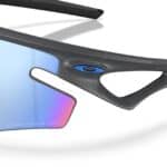 Close-up of the Oakley Sphaera Slash Matte Carbon temple with the Oakley icon
