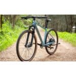 Polygon Heist 5 hybrid bike in Blue, front three-quarter view on a gravel path