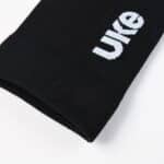 Close-up of the UKE logo on the black LingJun sock cuff