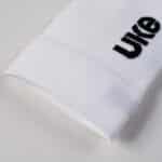 Close-up of the UKE logo on the white LingJun sock cuff